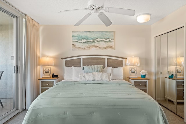 bedroom featuring a closet, a textured ceiling, carpet floors, and ceiling fan