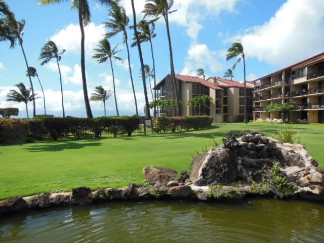 view of community featuring a water view and a lawn