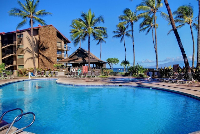 pool with a gazebo and a patio area
