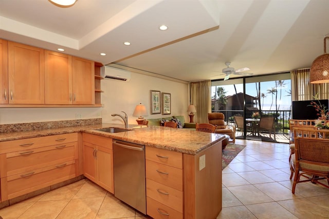 kitchen with a sink, a wall mounted air conditioner, light tile patterned flooring, a peninsula, and stainless steel dishwasher