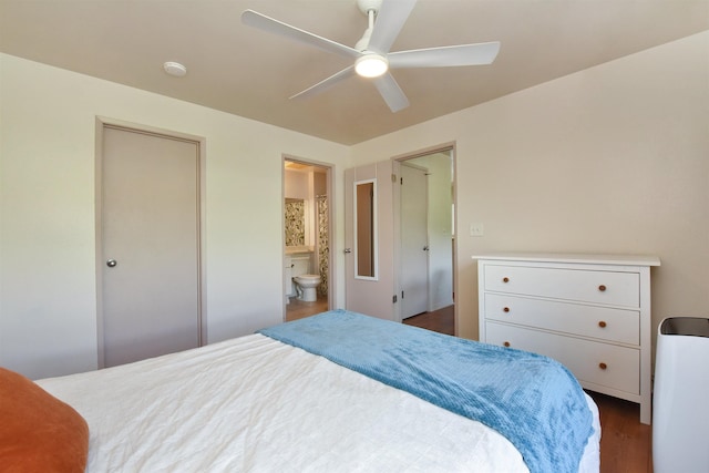 bedroom with dark wood finished floors, connected bathroom, and ceiling fan