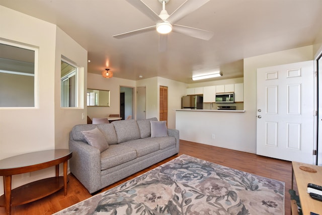 living area featuring wood finished floors and a ceiling fan