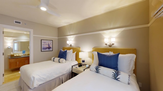 bedroom featuring a ceiling fan, visible vents, and connected bathroom