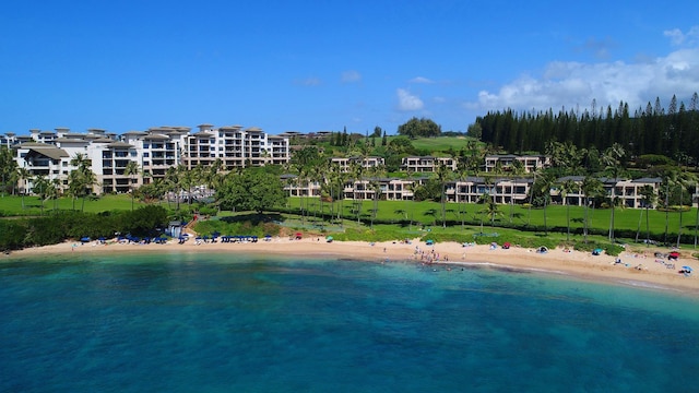 drone / aerial view with a beach view and a water view
