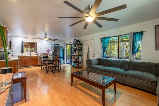 living room with light hardwood / wood-style floors and ceiling fan