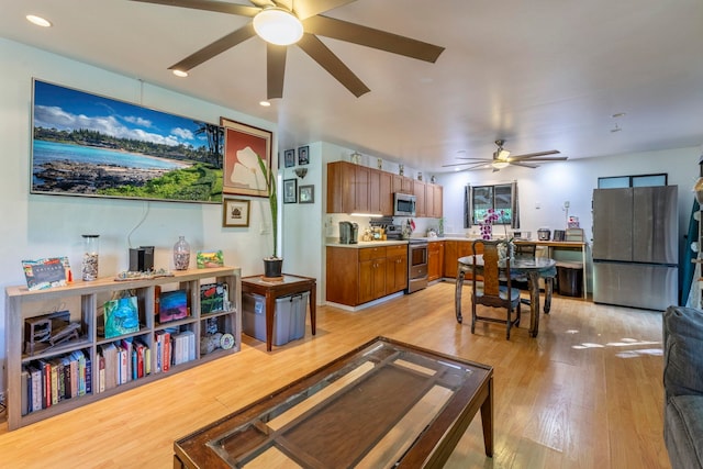 living room featuring light wood-type flooring and ceiling fan