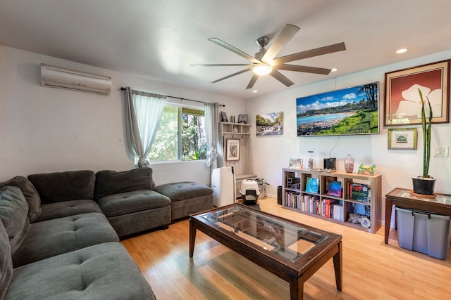 living room with an AC wall unit, hardwood / wood-style floors, and ceiling fan