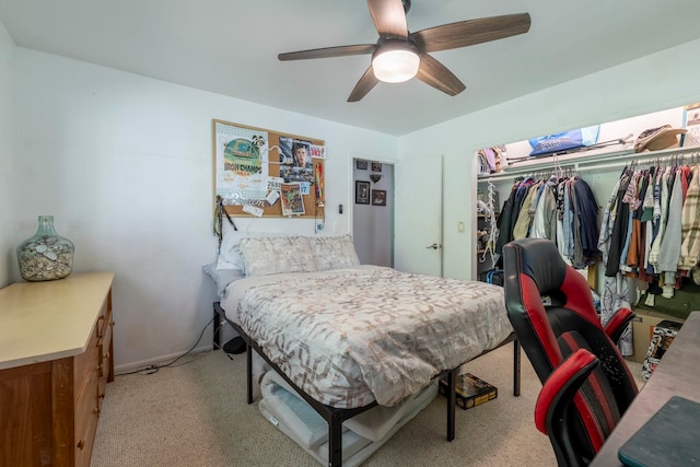 bedroom featuring a closet, light colored carpet, and ceiling fan