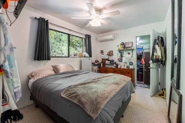 bedroom with ceiling fan, light carpet, a closet, and a wall mounted air conditioner