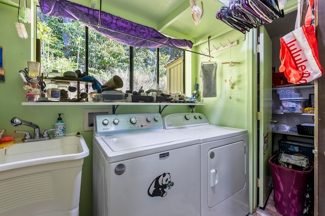 washroom with sink and washing machine and clothes dryer