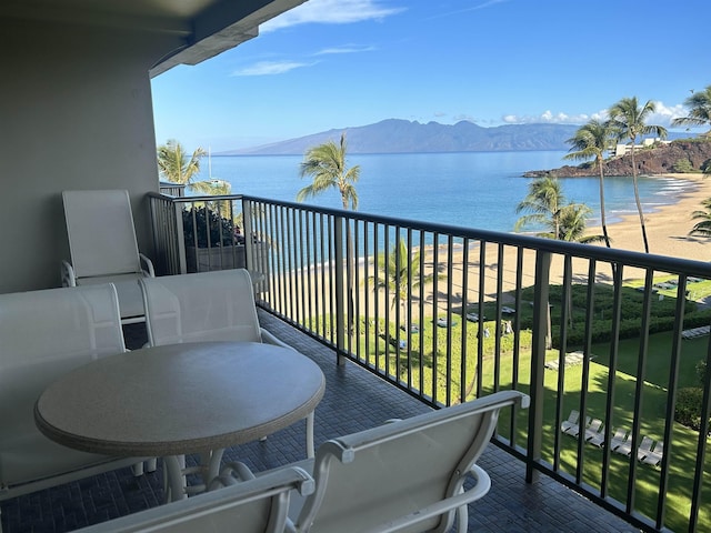 balcony featuring a water and mountain view