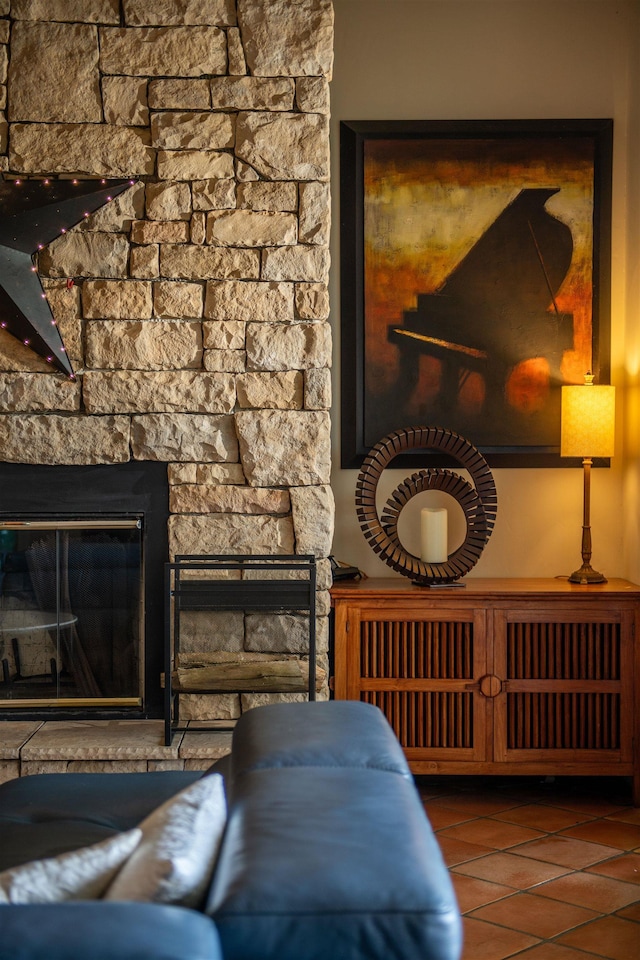 sitting room with tile patterned flooring and a stone fireplace