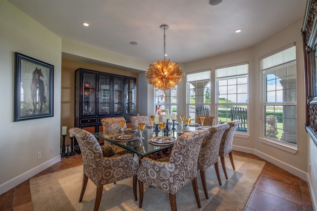 dining space with tile patterned flooring and a notable chandelier