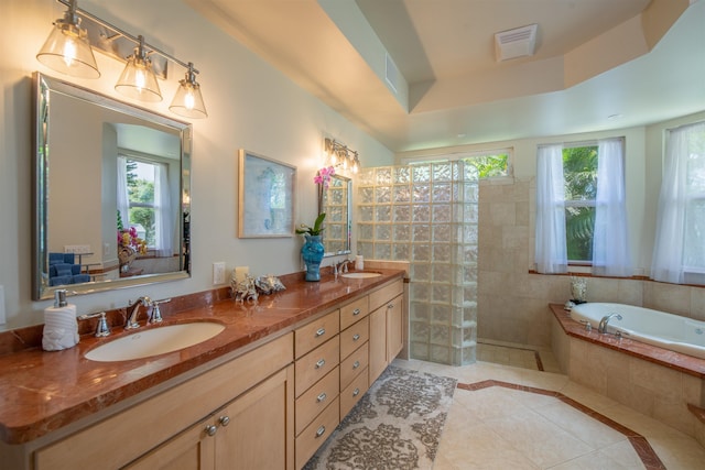 bathroom featuring a tray ceiling, vanity, separate shower and tub, and tile patterned flooring