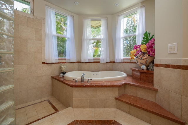 bathroom with tiled bath and tile patterned flooring