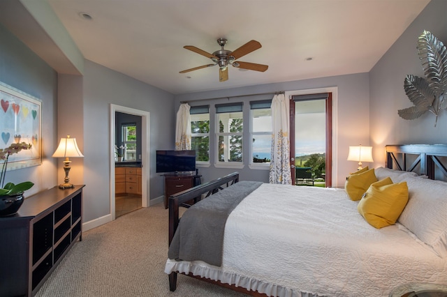 carpeted bedroom featuring ceiling fan and connected bathroom