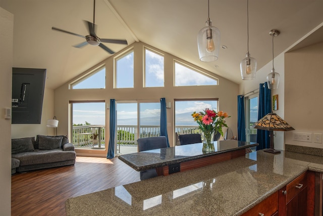 dining room featuring ceiling fan, a water view, high vaulted ceiling, and hardwood / wood-style floors