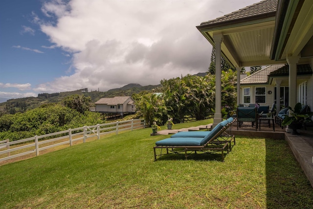 view of yard with a mountain view and a patio