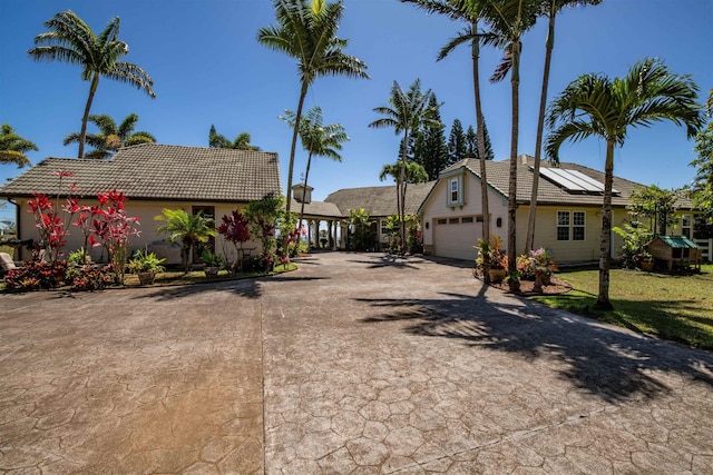 view of front of house with a garage and solar panels