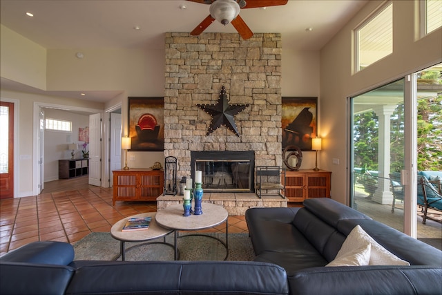 living room with a fireplace, light tile patterned floors, ceiling fan, and plenty of natural light