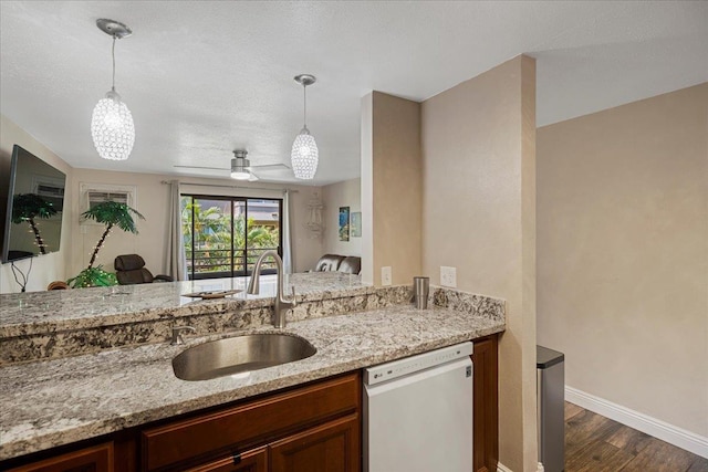 kitchen featuring dishwasher, decorative light fixtures, ceiling fan, and sink