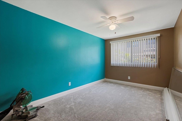 spare room with ceiling fan and light colored carpet