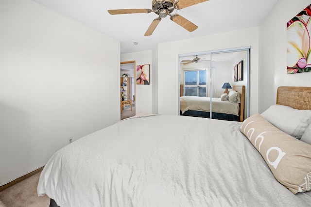 carpeted bedroom featuring a closet and ceiling fan