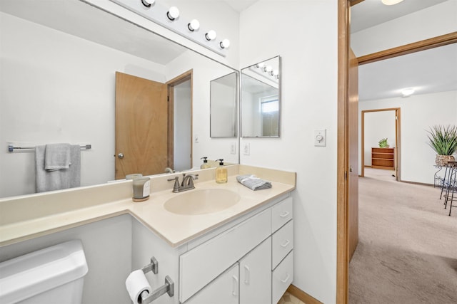 bathroom with toilet and vanity