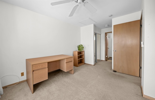 unfurnished office featuring ceiling fan and light colored carpet