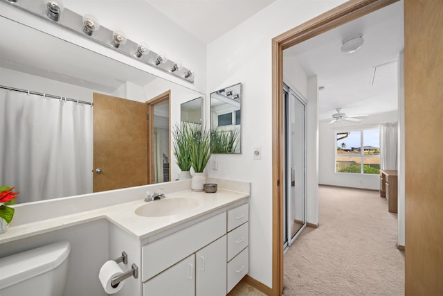 bathroom with ceiling fan, toilet, and vanity