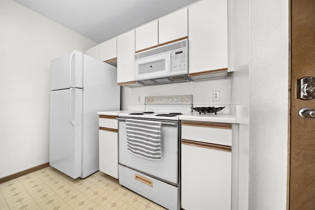 kitchen with white cabinets and white appliances