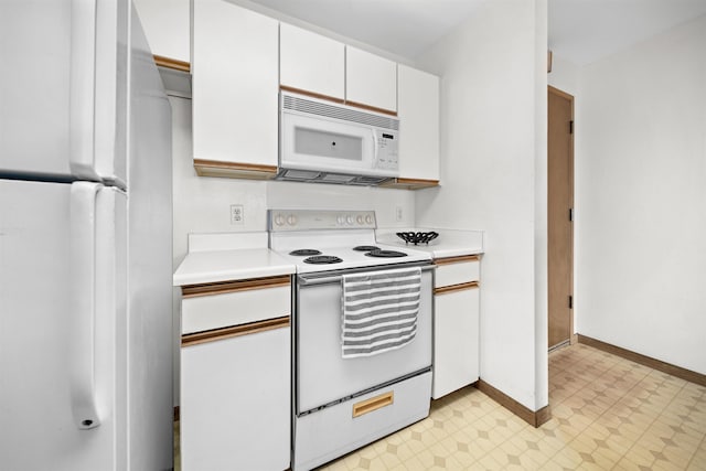 kitchen with white appliances and white cabinets