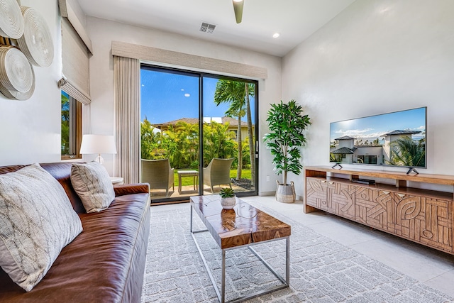 living room featuring light tile patterned flooring and a towering ceiling