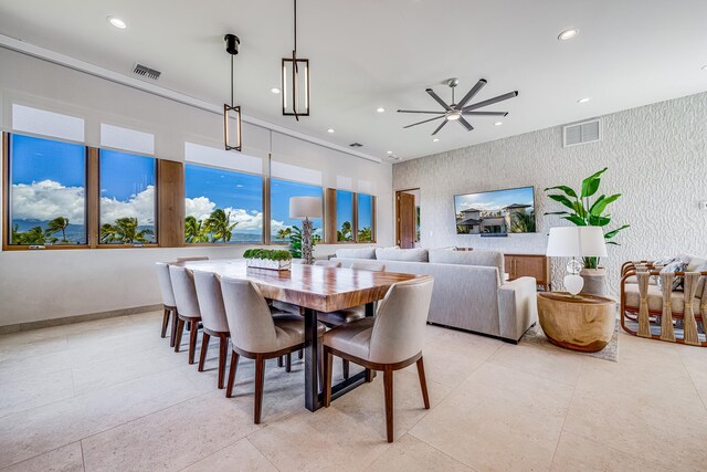 tiled dining space with ceiling fan