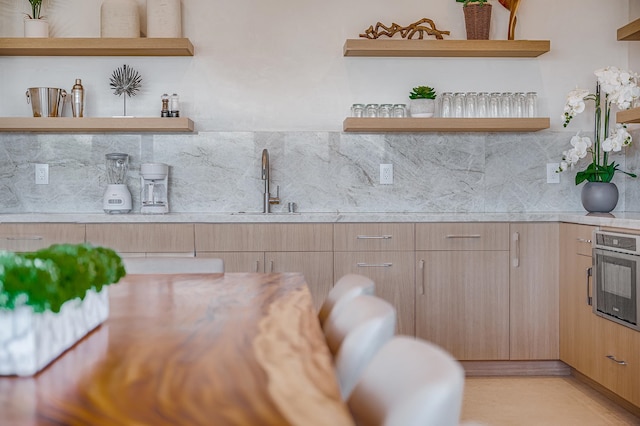 kitchen with backsplash, sink, and oven