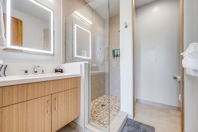 bathroom with toilet, an enclosed shower, tile patterned flooring, and vanity