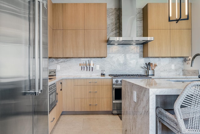 kitchen with sink, tasteful backsplash, light tile patterned floors, wall chimney range hood, and premium appliances