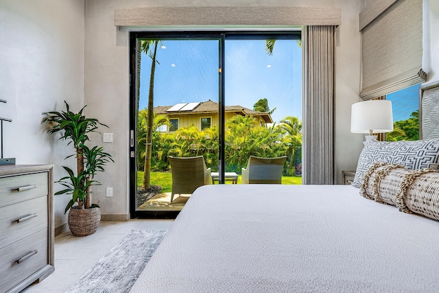 tiled bedroom featuring access to outside and multiple windows