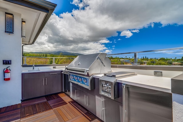 view of patio featuring sink, an outdoor kitchen, and grilling area