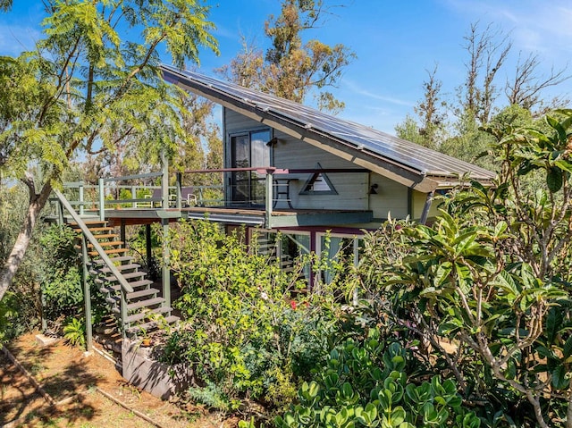 view of side of property with a wooden deck