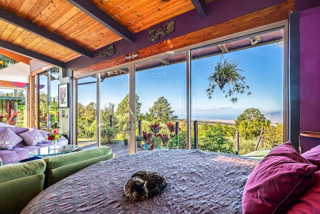 bedroom featuring beamed ceiling, multiple windows, and wooden ceiling