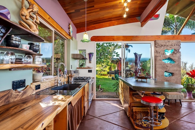 kitchen with sink, wooden ceiling, decorative light fixtures, vaulted ceiling, and stainless steel range with gas stovetop