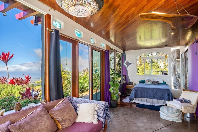 bedroom featuring concrete flooring, vaulted ceiling, multiple windows, and wooden ceiling