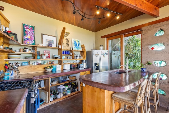 kitchen with a breakfast bar area, wooden ceiling, sink, and stainless steel appliances