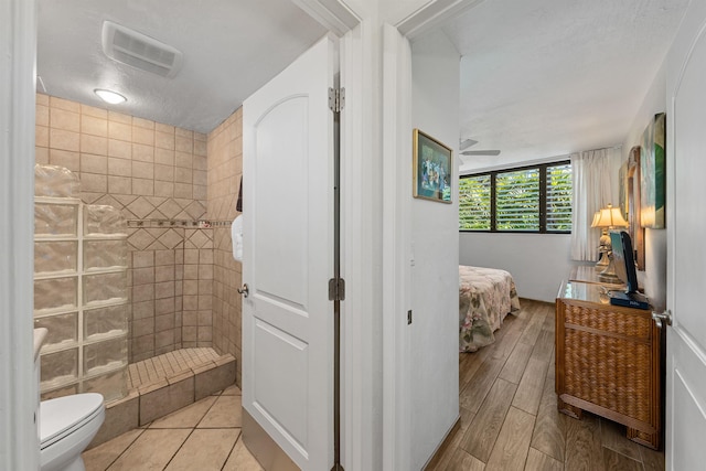 3975 Lower Honoapiilani Rd Unit 107, Lahaina, HI 96761 - full bath featuring a walk in shower, connected bathroom, toilet, and wood finished floors