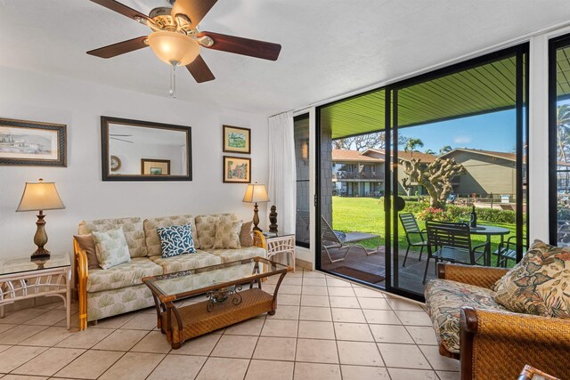 3975 Lower Honoapiilani Rd Unit 107, Lahaina, HI 96761 - living room with floor to ceiling windows, ceiling fan, and light tile patterned floors