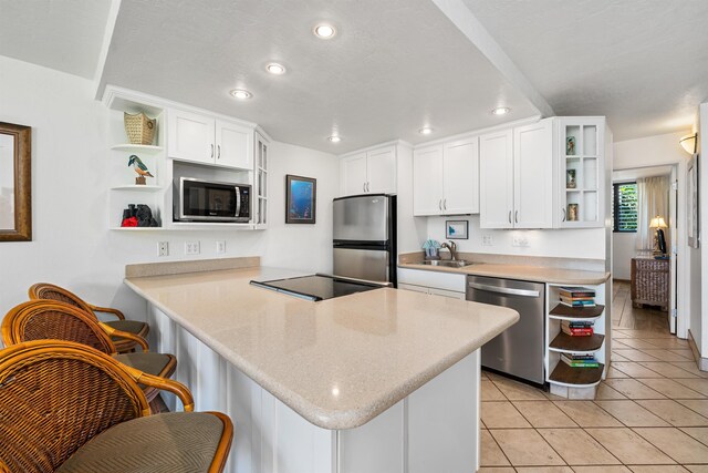 3975 Lower Honoapiilani Rd Unit 107, Lahaina, HI 96761 - kitchen with open shelves, appliances with stainless steel finishes, a sink, a peninsula, and recessed lighting