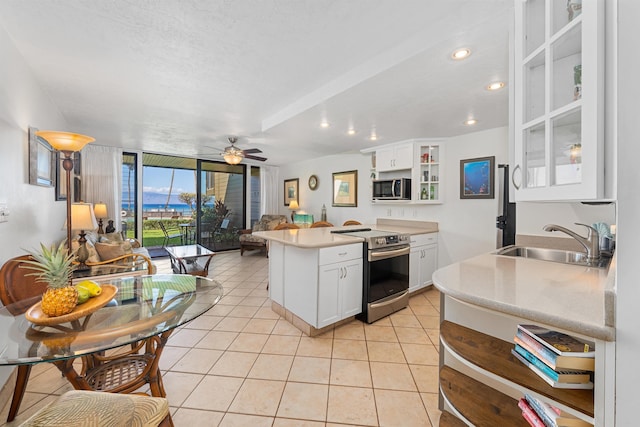 3975 Lower Honoapiilani Rd Unit 107, Lahaina, HI 96761 - kitchen with stainless steel appliances, a sink, open shelves, a peninsula, and open floor plan