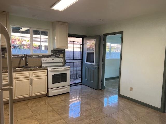 kitchen featuring sink, tasteful backsplash, white electric range oven, and light tile floors