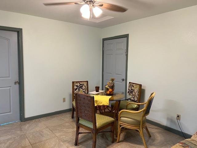 dining area with tile flooring and ceiling fan